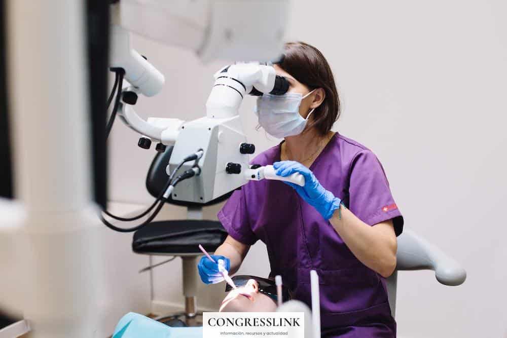 Woman in Purple Scrub Using a Dental Equipment in Examining a Patient